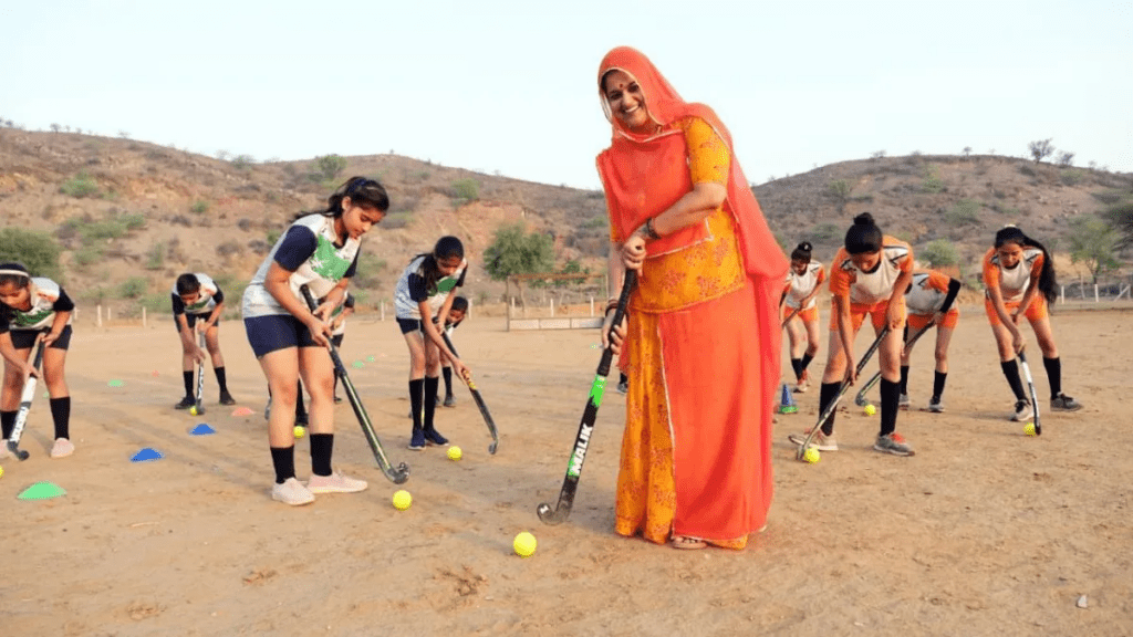 Family support in rural India: a young girl training in cricket with relatives in a village setting, reflecting the quiet resilience and encouragement behind Nallapureddy Charani's journey.