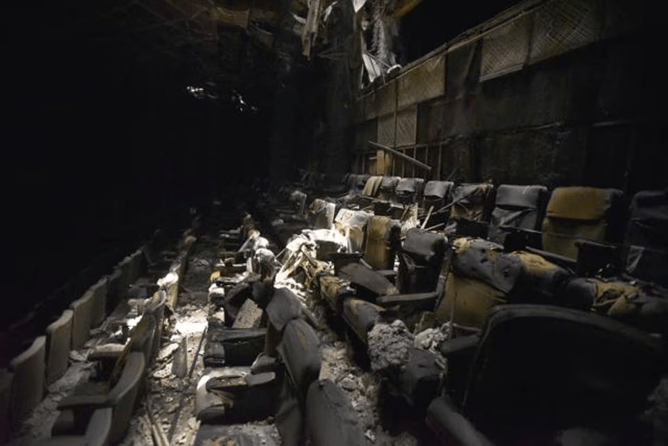 Charred and abandoned seats inside Uphaar Cinema hall in Delhi, where safety failures like locked exits and poor maintenance led to 59 deaths in the 1997 fire.
