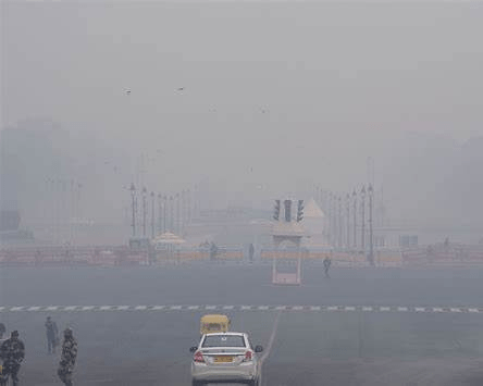 Dense winter fog engulfing roads and streets in North India, reducing visibility and showing impact of cold wave weather.