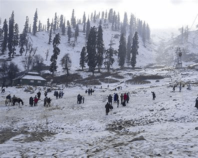 Snow‑covered valley and hills in Kashmir during heavy winter snowfall showing cold conditions in mountainous regions.