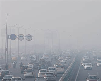 Traffic moving slowly on highways and city roads under thick fog conditions, showing reduced visibility.