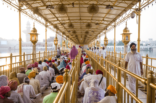 Sikh pilgrims walking together at Golden Temple reflecting discipline and collective harmony
