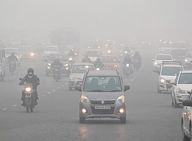 Vehicles and trains delayed due to dense fog in India, illustrating travel disruptions from weather.