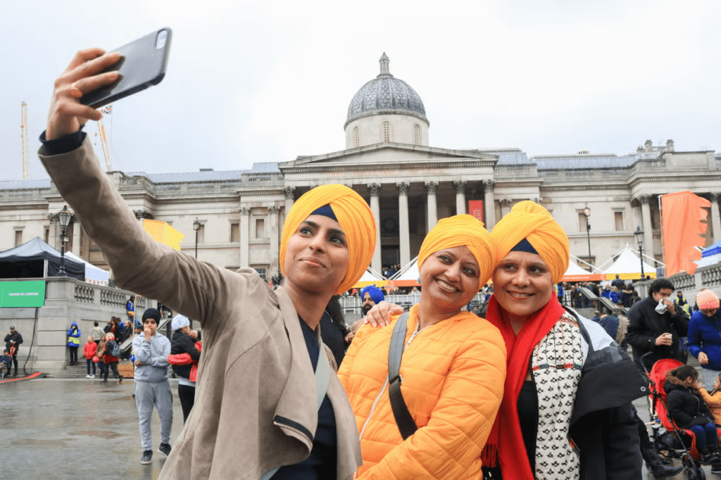 Turbaned Sikh women celebrating modern identity leadership and community presence worldwide