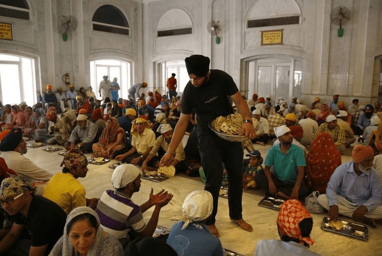 Seva in gurdwara langar hall reflecting equality humility and living Sikh values