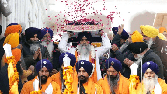 Sikh devotees offering prayers in a gurdwara during Guru Gobind Singh Jayanti celebrations, honoring the birth and teachings of courage and Khalsa creation.