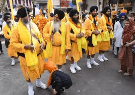 Nagar kirtan procession on Guru Nanak Jayanti, carrying the Guru Granth Sahib through streets to spread messages of equality and divine remembrance.